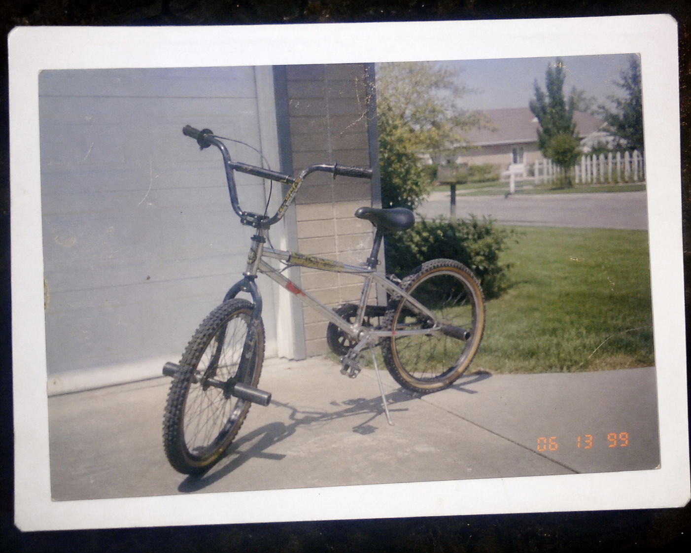 Scanned 90s print photo of Matt's bike leaning in the driveway